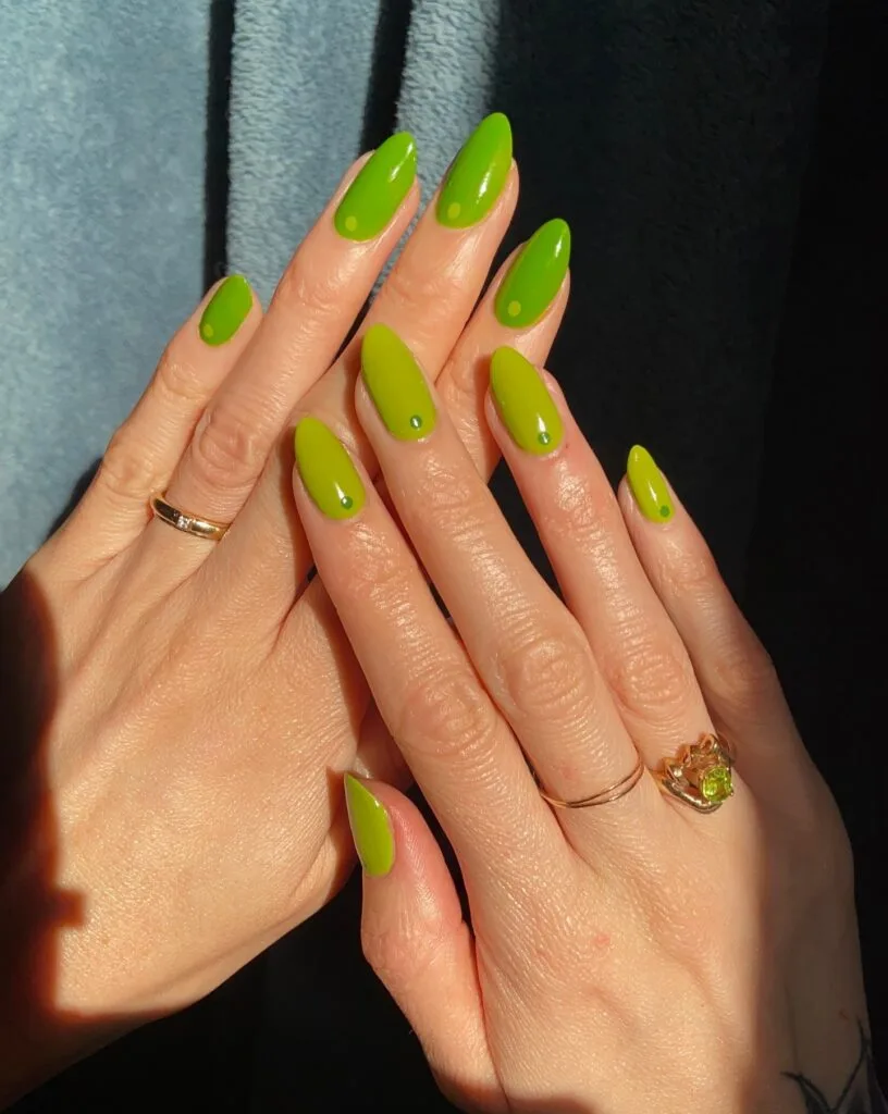 august nail colors 2026, almond chartreuse green nails with mini green dot accents
