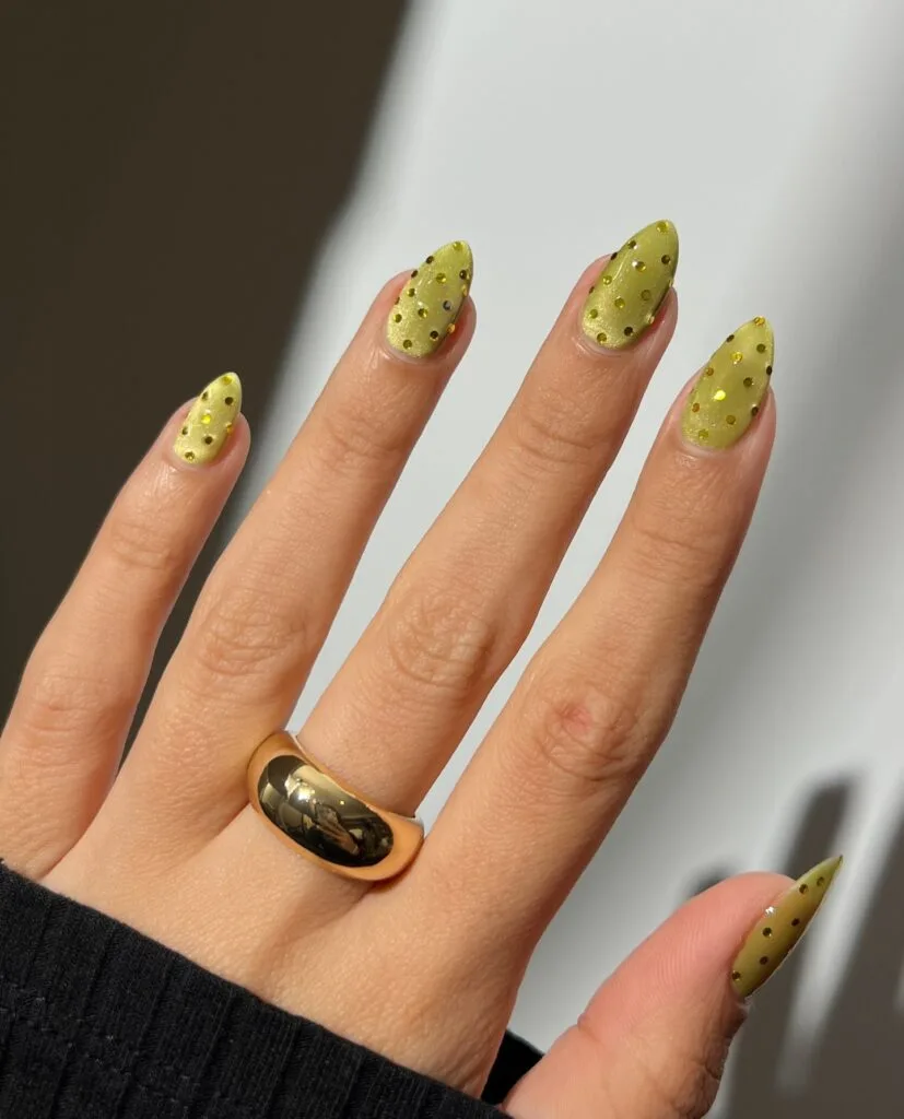 summer nail colors, shimmery chartreuse almond nails with gold sequin dots