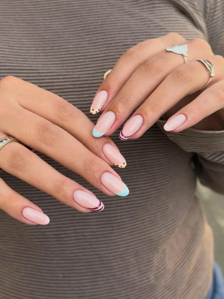 summer nails, long almond sheer pink nails with aqua, butter yellow polka dot, and burgundy swirl French tips
