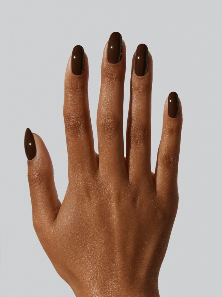 Deep espresso brown almond nails against a white background, an autumn nails idea.