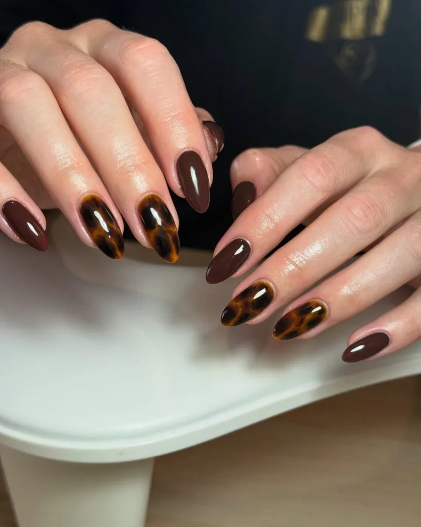 Almond tortoiseshell nails mixed with glossy chocolate brown solid nails.
