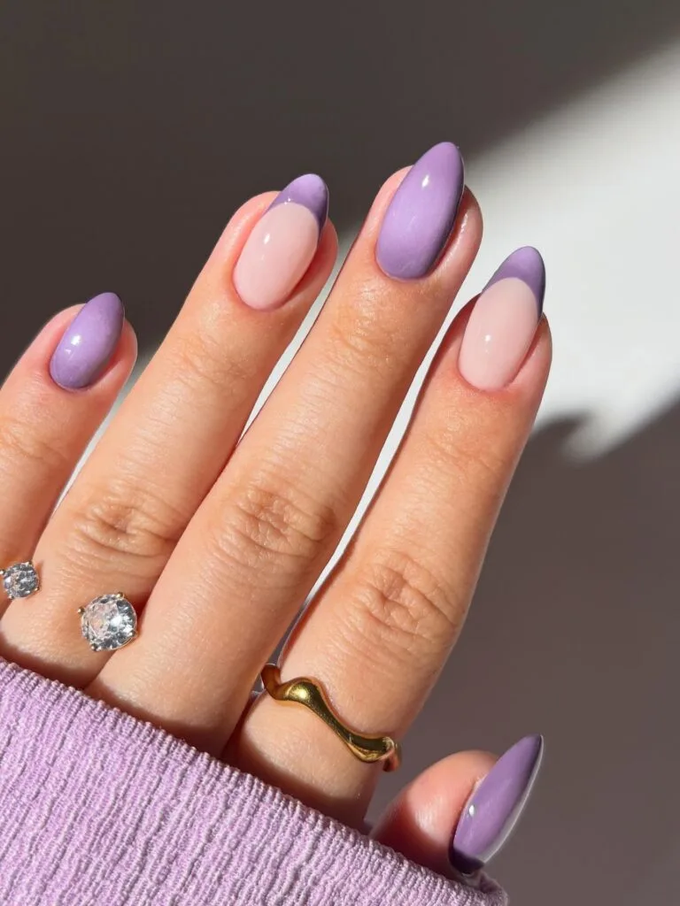 Lavender fall aura nails with pale pink bases, blurred purple French tips, and solid lilac accents.