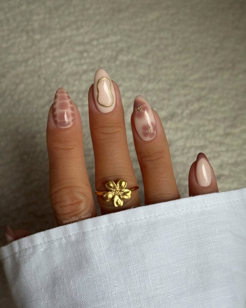 Neutral fall nail design with blush croc texture, gold outlines, tiny studs, and text “monika_nails.”