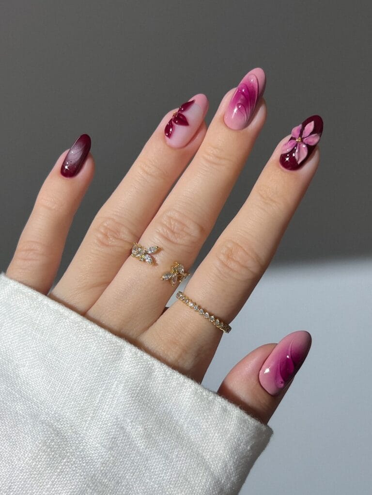 Berry fall aura nails with sheer pink bases, burgundy fades, raised petals, and floral accents.
