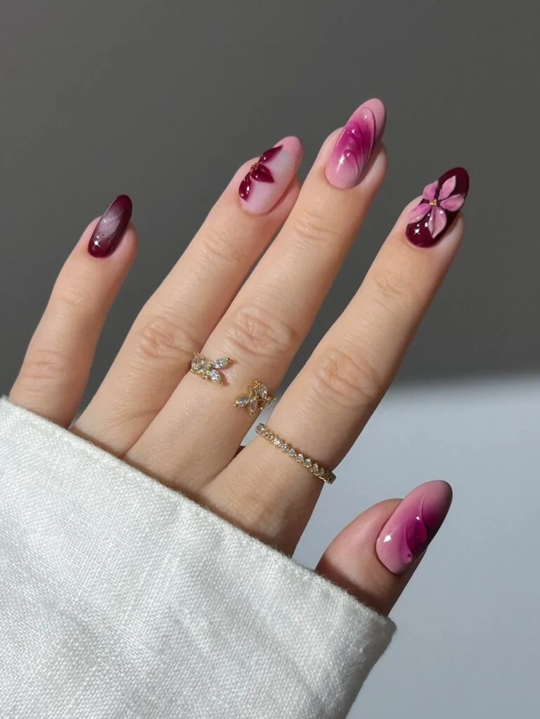 Berry fall aura nails with sheer pink bases, burgundy fades, raised petals, and floral accents.