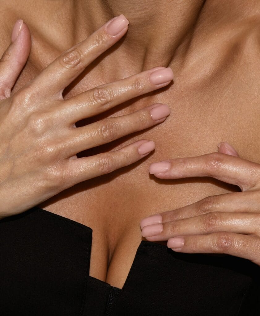 Short square nude nails in a sheer pale pink shade with a glossy finish.
