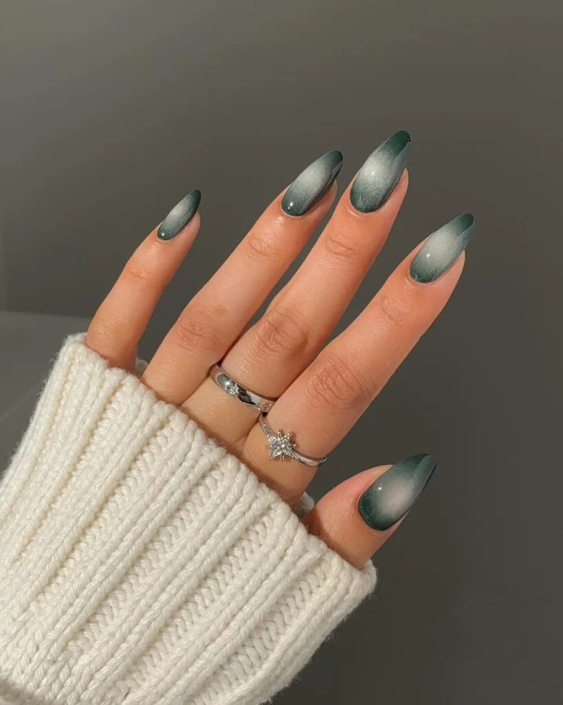 Forest green fall aura nails with pale smoky centers and glossy almond shapes.