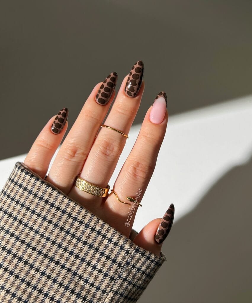 Chocolate croc-print neutral fall nails with warm brown bases and one milky accent nail.