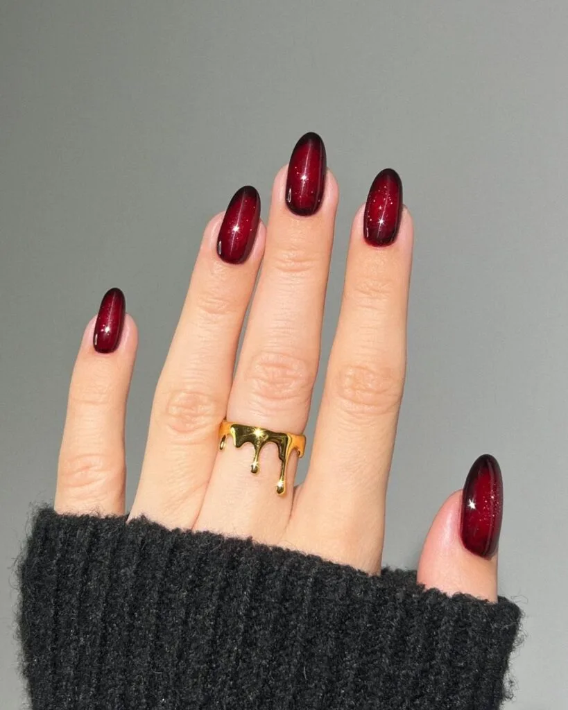 Garnet autumn 2026 nails with deep red aura shading, fine sparkle, and a glossy finish.