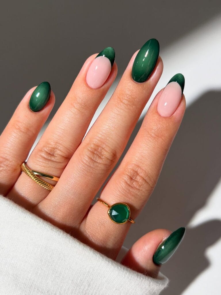 Emerald fall aura nails mixed with pale pink bases and dark green French tips.
