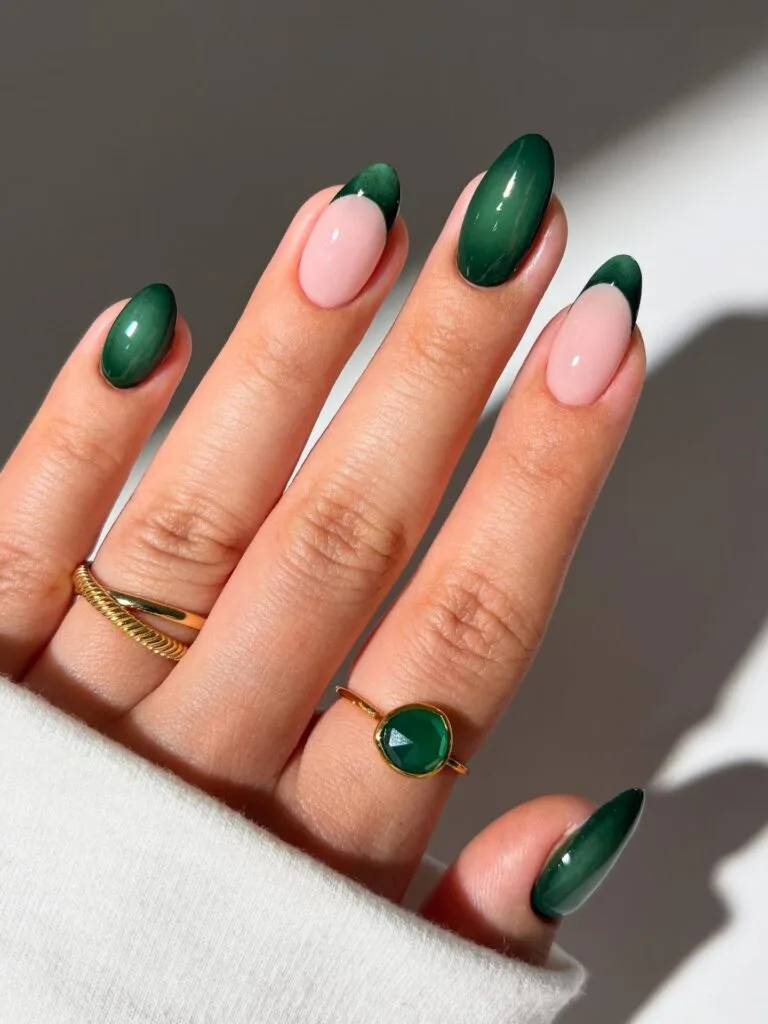 Emerald fall aura nails mixed with pale pink bases and dark green French tips.