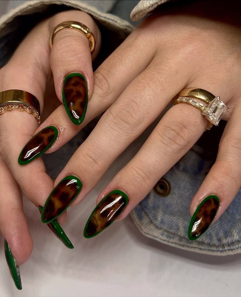 Long almond autumn nails 2026 in amber tortoiseshell outlined with a bright green border