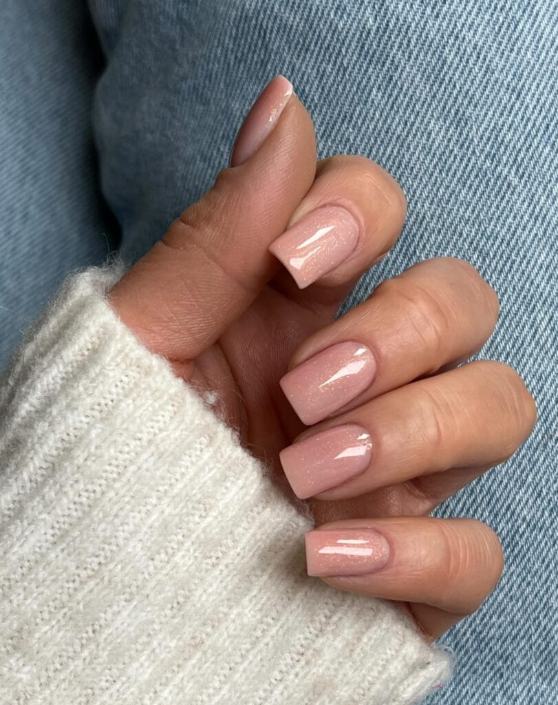 Soft pink nude square nails with subtle shimmer and a glossy finish.
