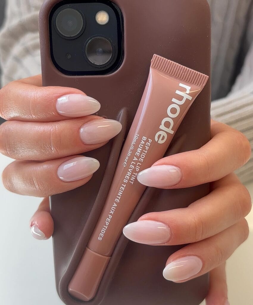 Milky nude almond nails with a glossy finish
