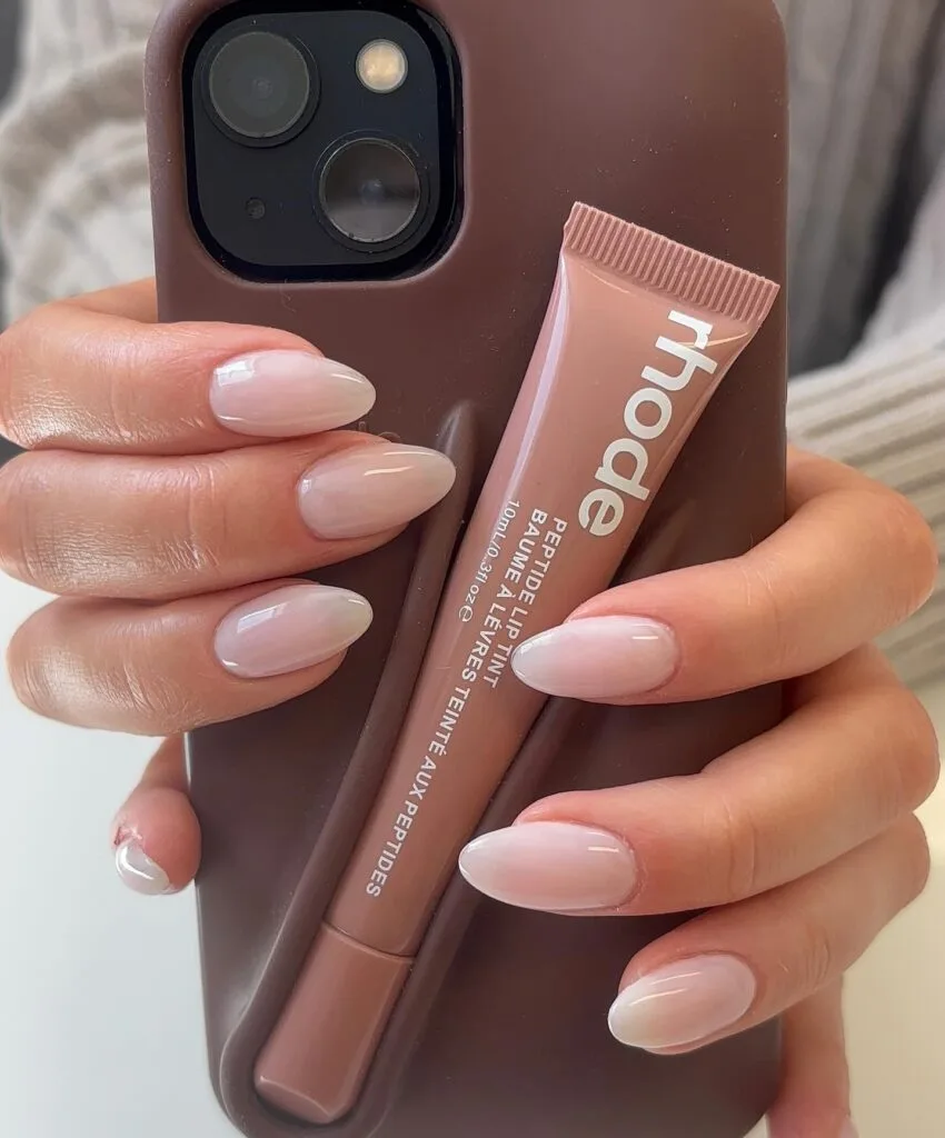 Milky nude almond nails with a glossy finish