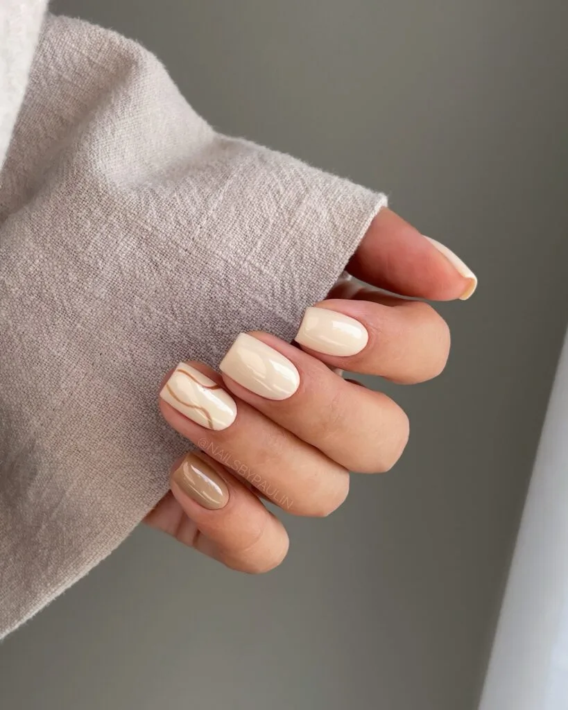 Short square warm sand nails in cream and beige with fine brown line art