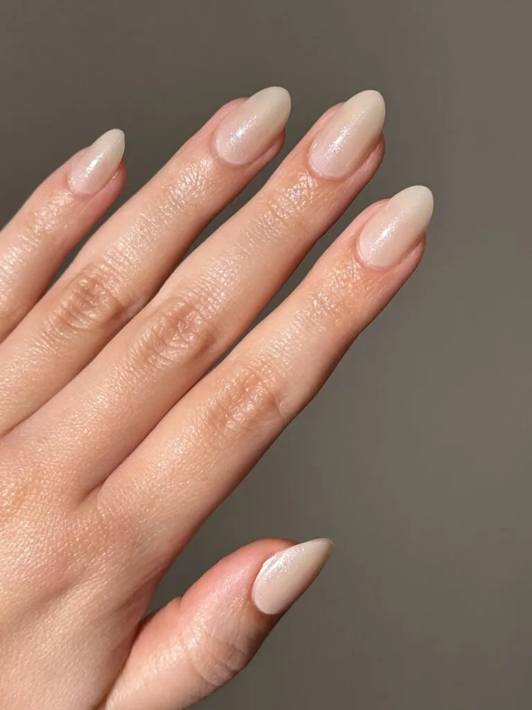 Almond warm beige nails with a soft pearly sheen, a neutral September nails idea.