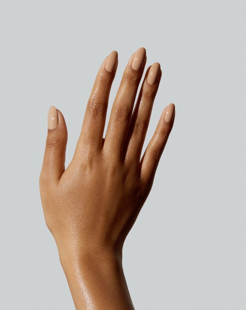 Glossy warm sand nude nails on a medium almond shape, a simple autumn nails look.