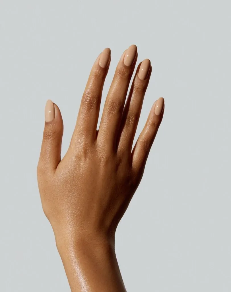 Glossy warm sand nude nails on a medium almond shape, a simple autumn nails look.