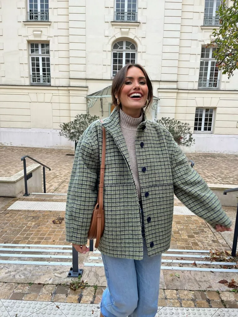 Woman in a green check jacket, turtleneck, and jeans for a casual autumn outfit.