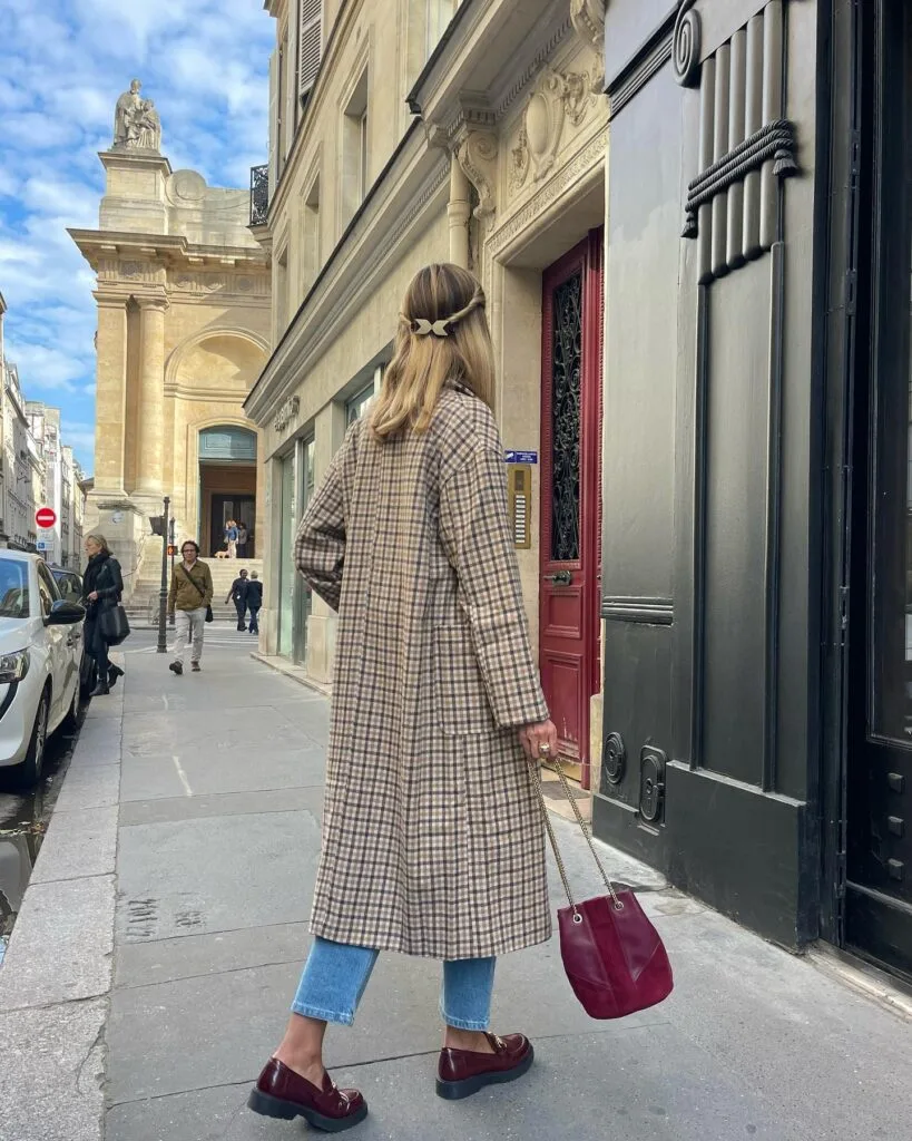 Long plaid coat with cropped jeans, burgundy loafers, and matching bag in a fall 2026 outfit.