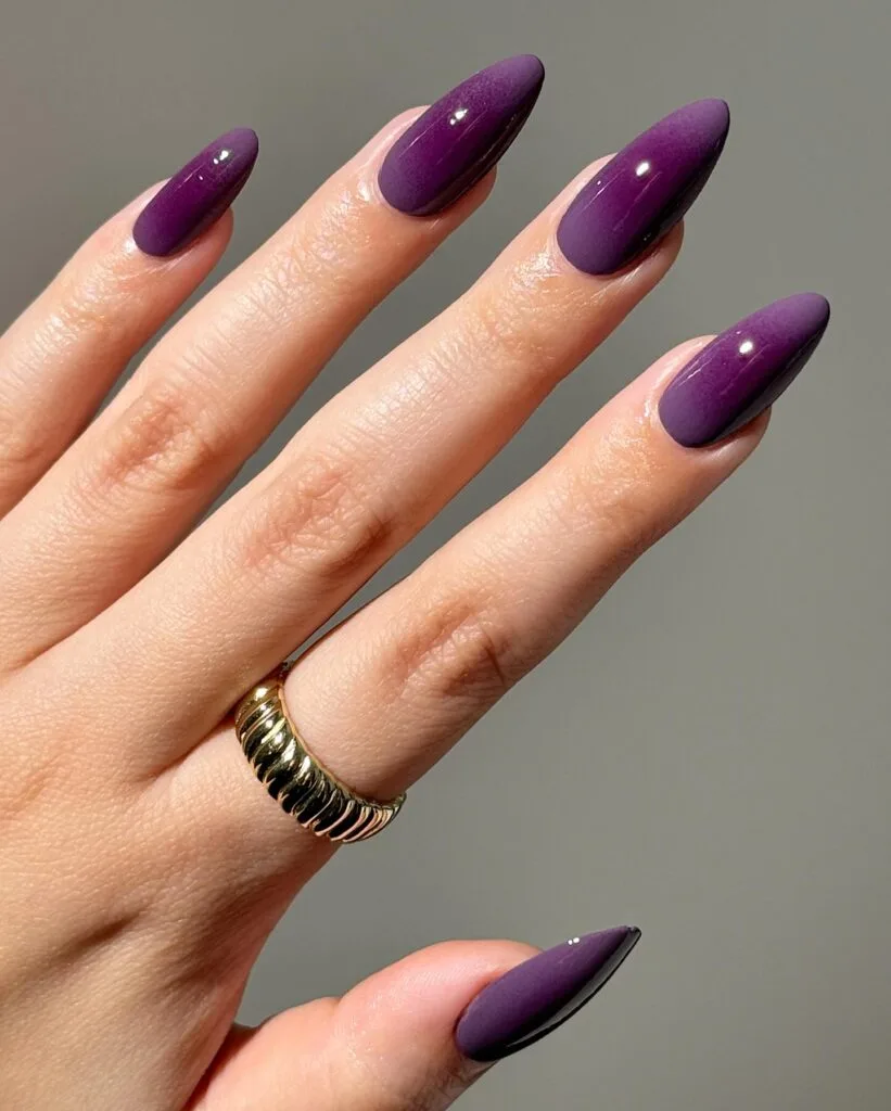 Long almond sugar plum nails in rich purple with a glossy finish for early fall nails.