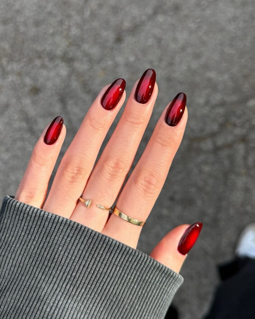 Glossy ruby red autumn 2026 nails with bright jelly centers and deep wine aura edges.
