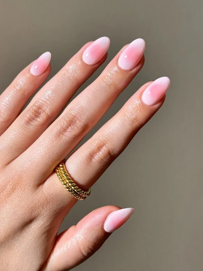 Milky blush nude almond nails with a soft pink center and glossy finish for September nails.