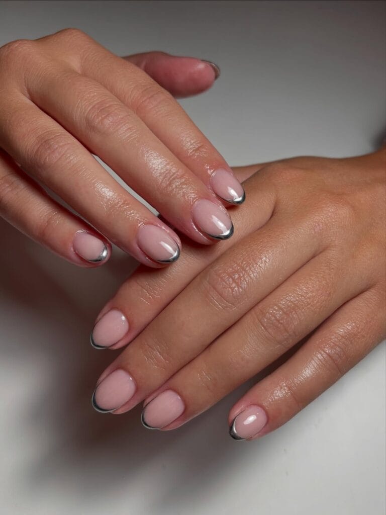 Short oval fall nail trends in milky nude with a thin silver chrome micro French tip