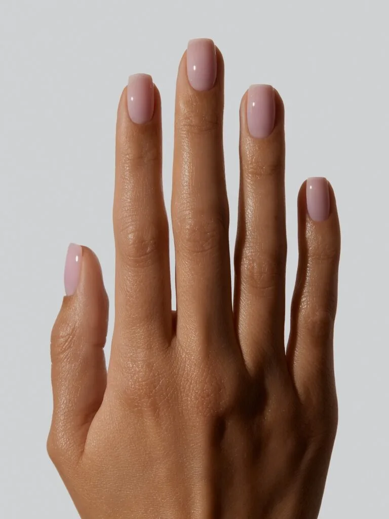 Short square milky blush nails in a pale peachy pink, a soft fall nail colors look.