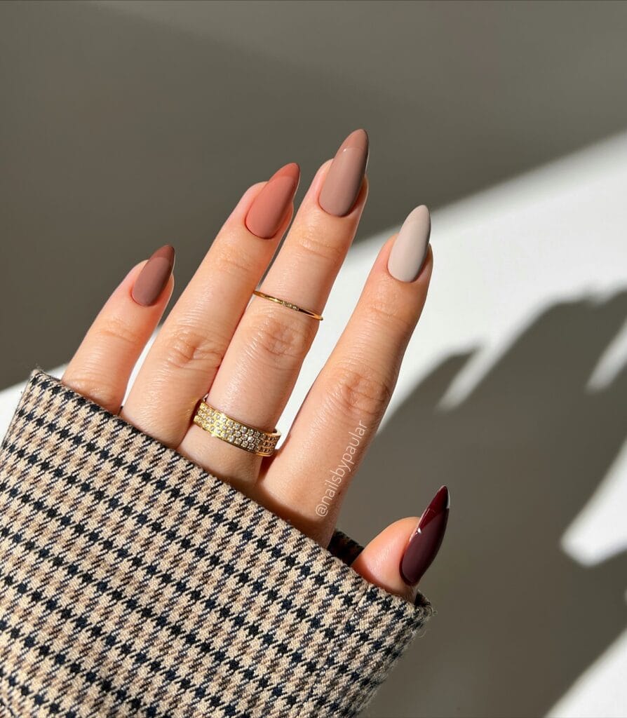 Neutral fall nails in muted autumn shades with matte bases and matching glossy French tips.
