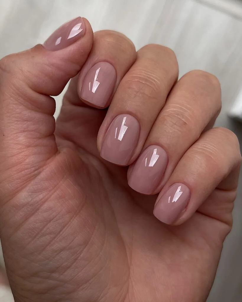 Glossy mauve nude nails with a glass lacquer finish, a simple early fall nails look.