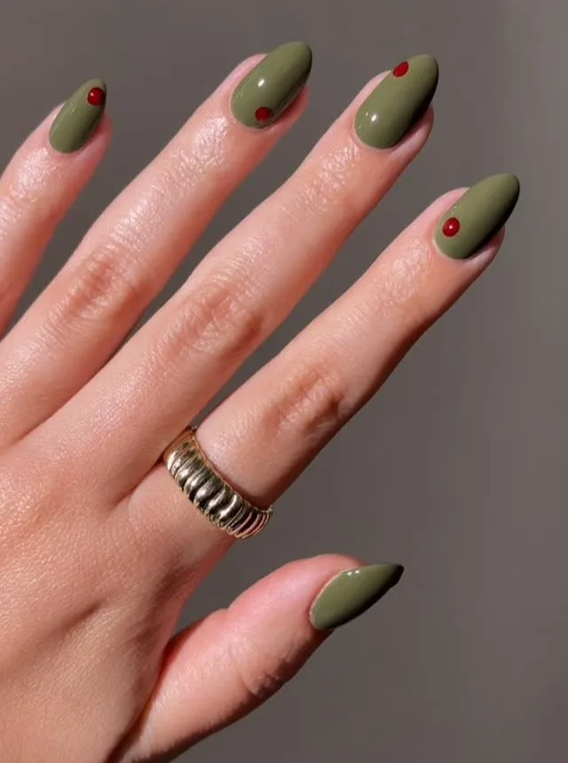 Burnt olive almond nails with tiny red dot accents, an autumn nails idea.