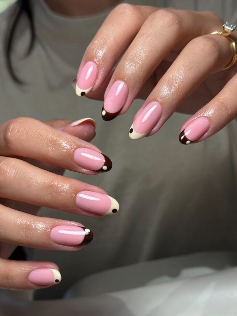 Short September nails with chocolate and cream French tips and tiny contrasting dots.