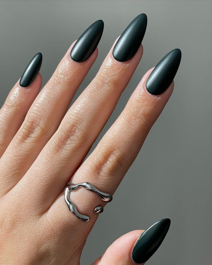 Long almond dark teal nails with a soft satin finish for early fall nails.