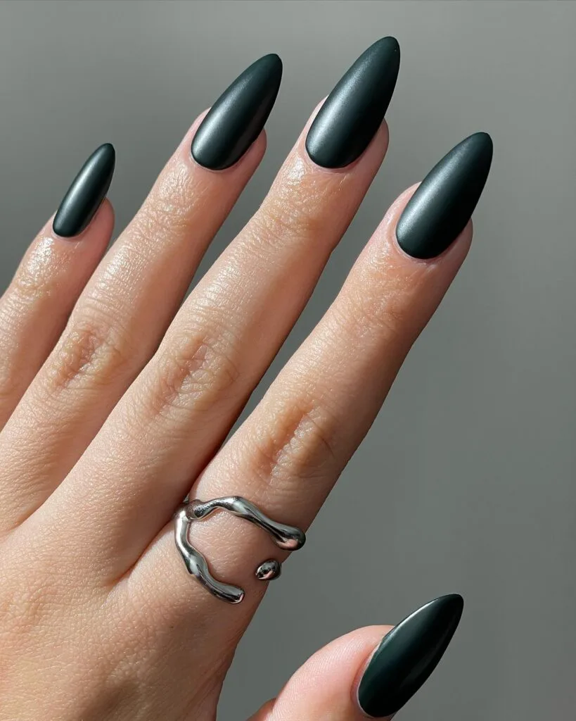 Long almond dark teal nails with a soft satin finish for early fall nails.