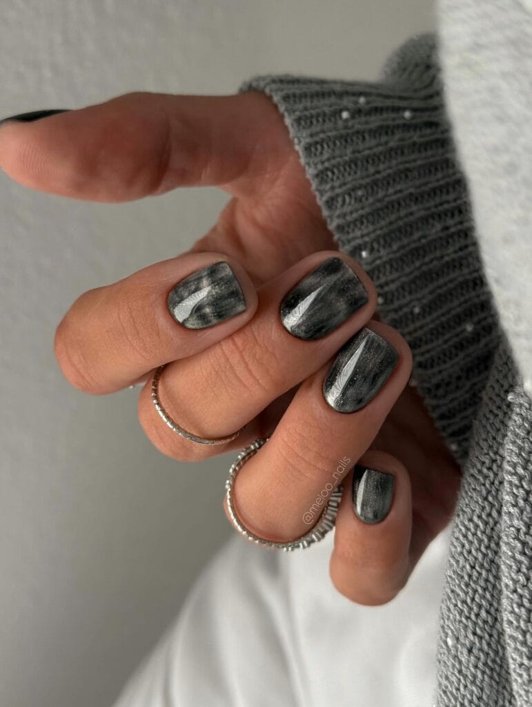 Short square autumn nail trends in a charcoal gray smoke wash with a white streak of light