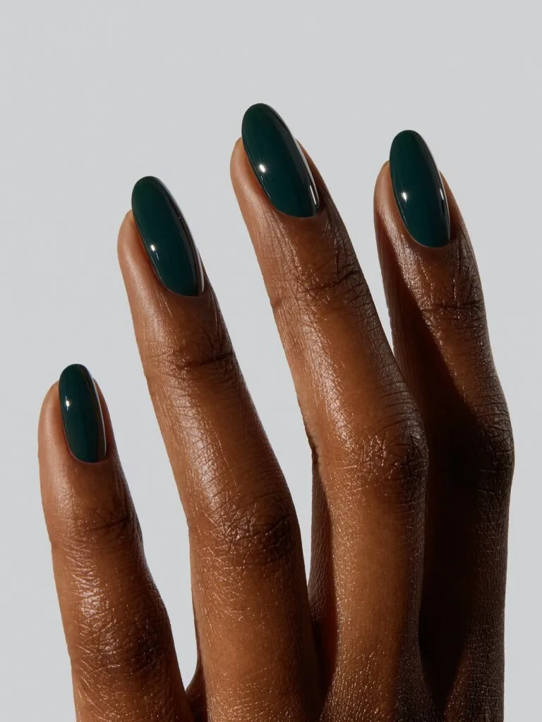 Long almond dark teal nails with a deep glossy finish, an autumn nail colors idea.
