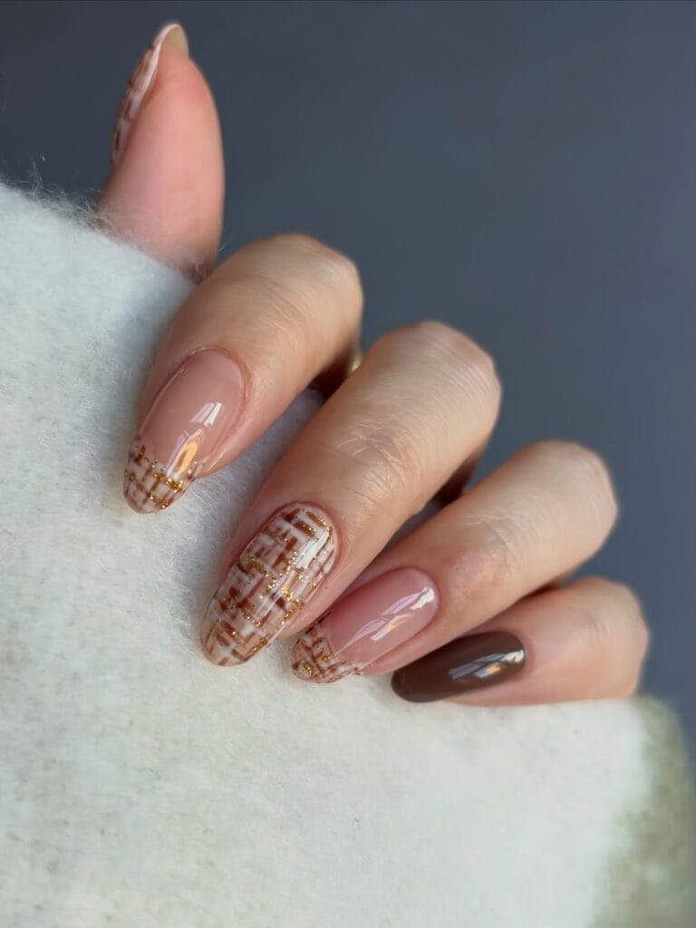 Almond fall nail trends with brown and cream tweed French tips and gold glitter threads