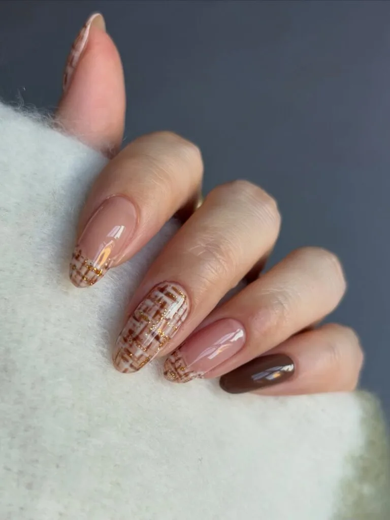 Almond fall nail trends with brown and cream tweed French tips and gold glitter threads