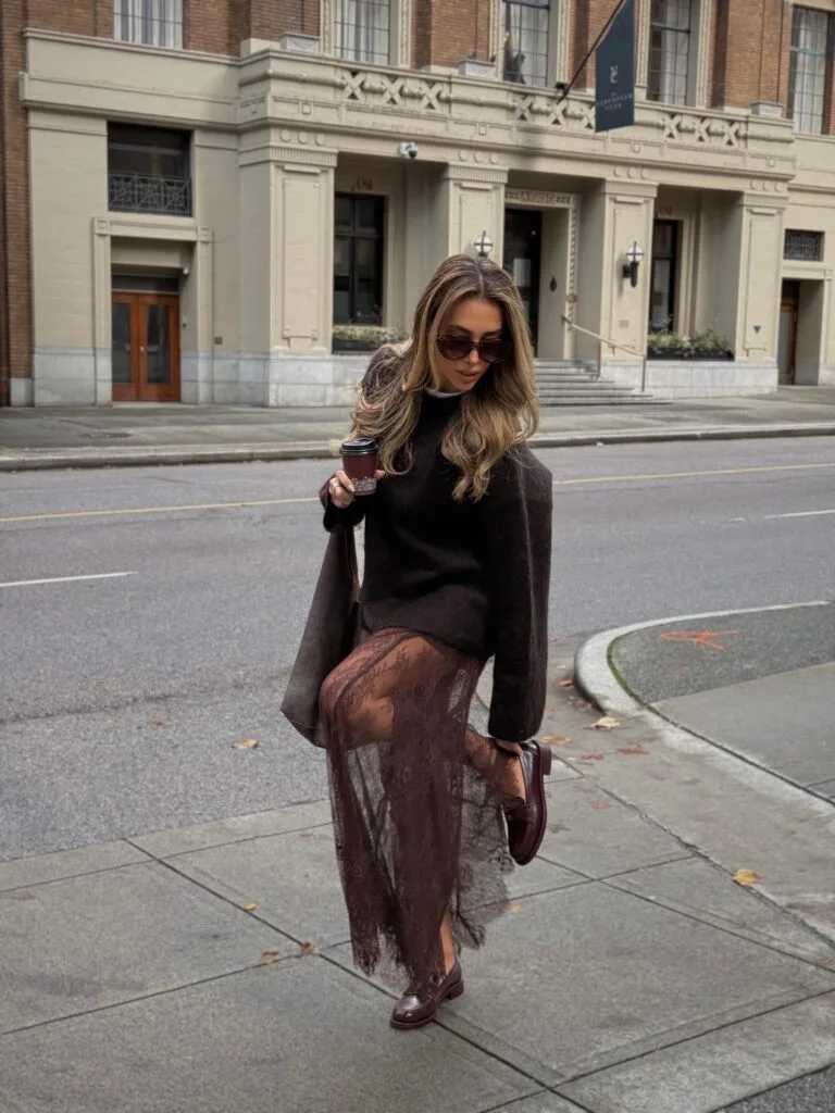 Brown lace skirt with a dark sweater and burgundy loafers in an autumn outfit.