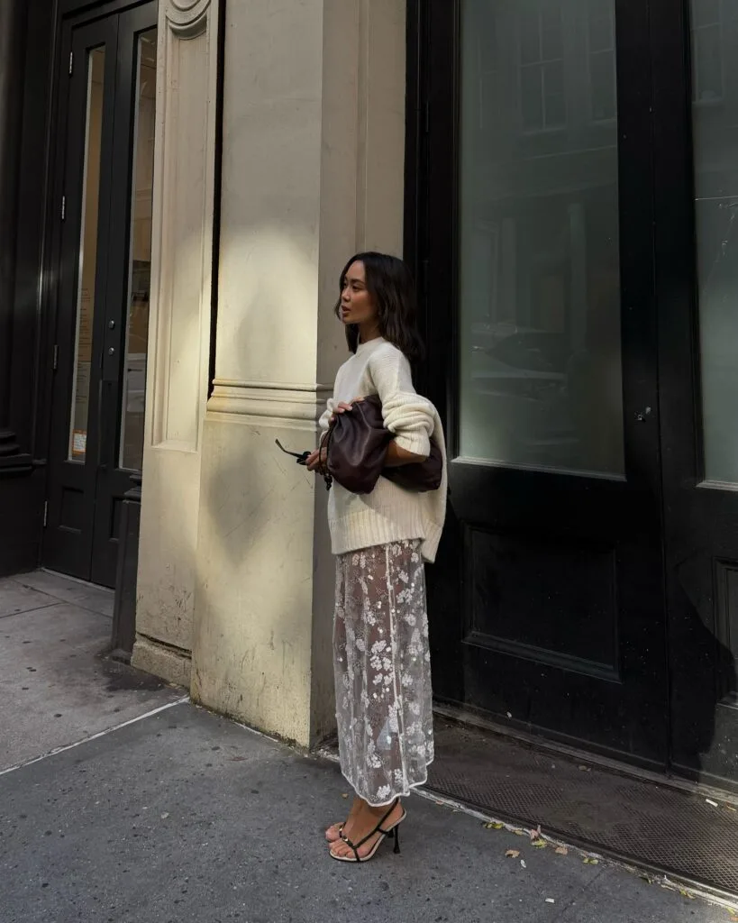 Cream sweater with a sheer embellished skirt and heels in a layered fall outfit.