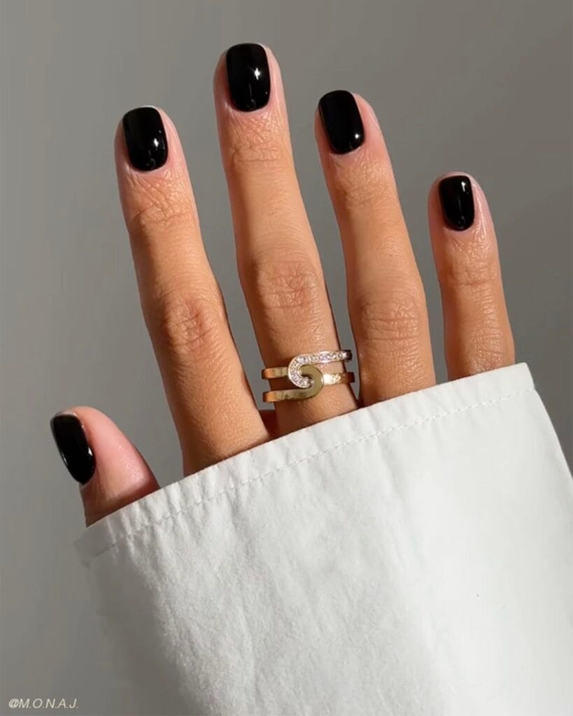 Short glossy black nails with a clean rounded-square shape, fall nails