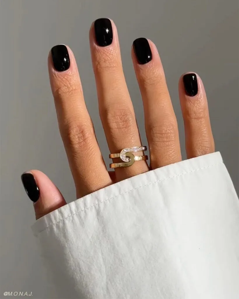 Short glossy black nails with a clean rounded-square shape, fall nails