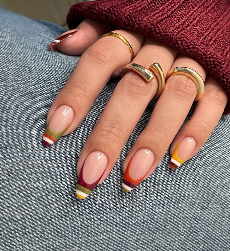 Long almond 2026 autumn nails with layered striped French tips in burgundy, olive and mustard
