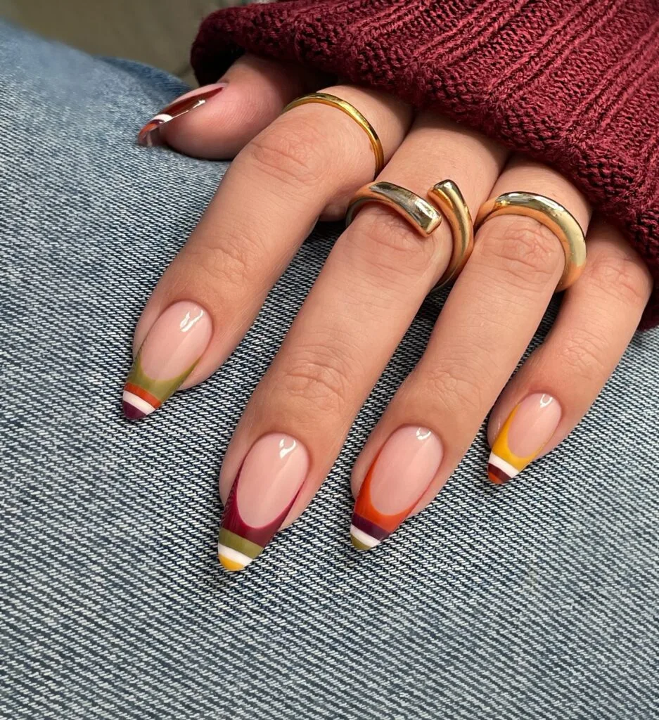 Long almond 2026 autumn nails with layered striped French tips in burgundy, olive and mustard