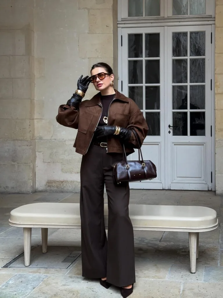 Woman in layered chocolate brown pieces with wide-leg pants for a tonal fall 2026 outfit.