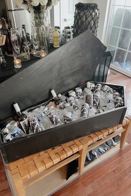 Halloween drink tub shaped like a coffin and filled with ice, wine, and bottled drinks
