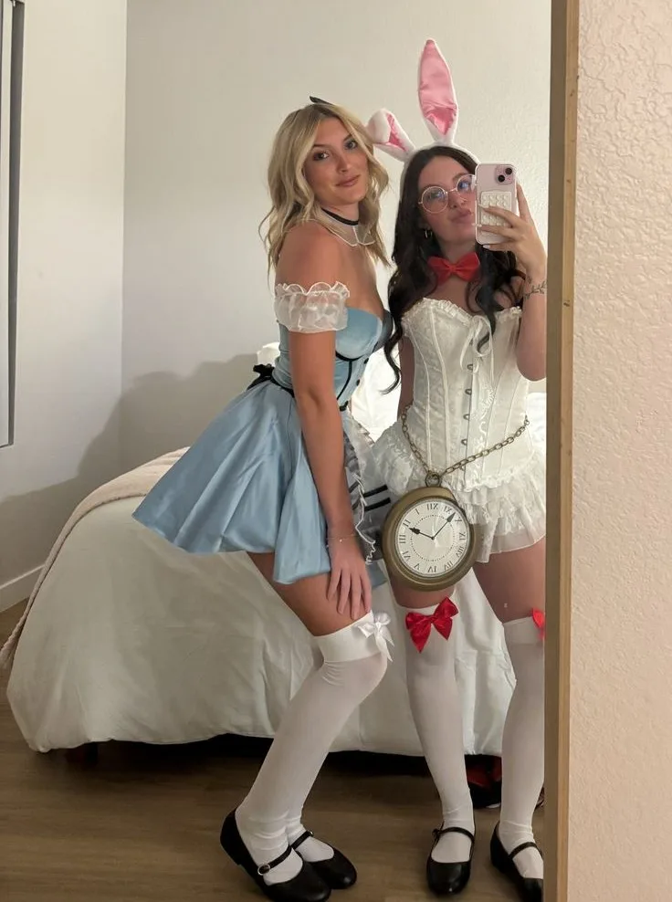 Alice and White Rabbit Halloween costumes for friends with a blue dress, white corset, bunny ears, and clock bag.