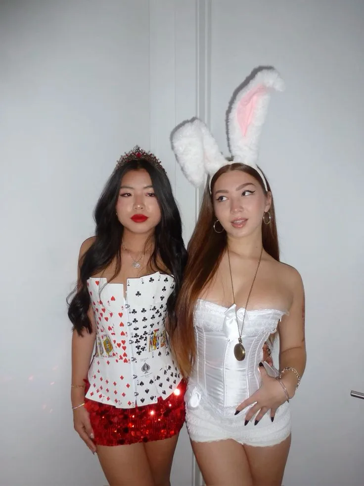 Best friend Halloween costumes as Queen of Hearts and White Rabbit with card corset, bunny ears, and pocket watch.